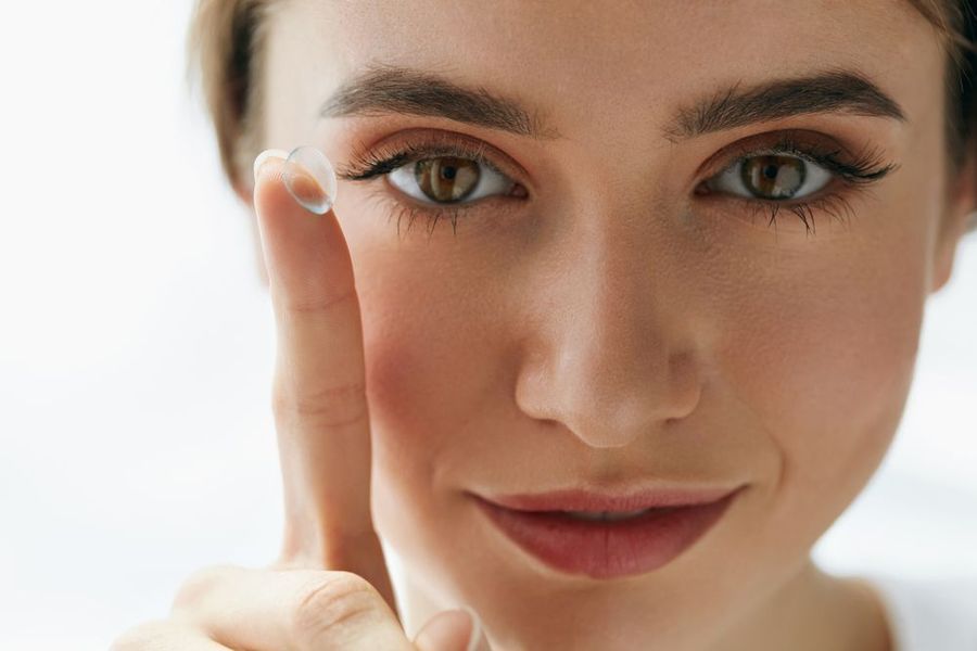 Beautiful Woman holding a contact lense